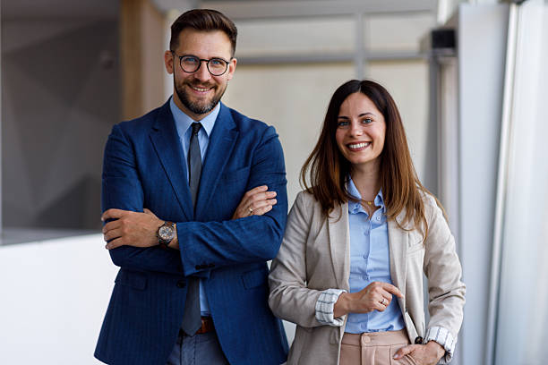 istock Confident businesspeople standing with crossed arms, representing professional collaboration in contemporary workplace environment 2220453474