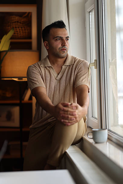 istock Pensive serious man looking away at home 2220453596