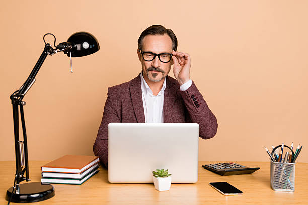 istock Portrait of attractive skilled focused man programming it finance project making decision isolated over beige color background 2220455697