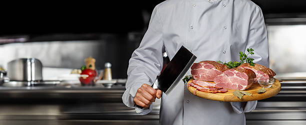 istock Chef cooks gourmet meats in a pro kitchen. 2220455980