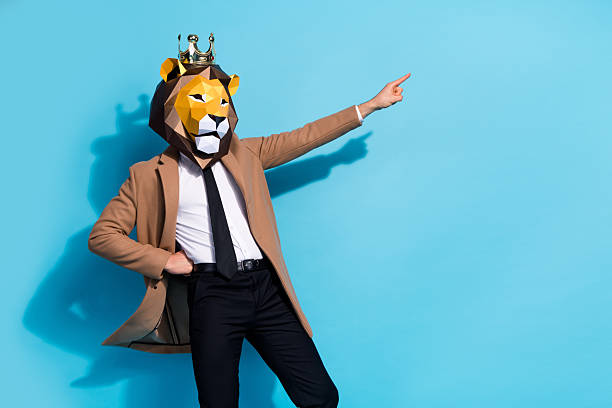 istock Photo of weird eccentric guy lion mask character point hand empty space offer theme event isolated over blue color background 2220456836