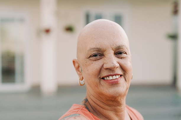 istock Bald cancer survivor enjoying sunlight in backyard 2220457359
