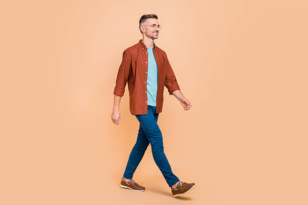 istock Full length profile side photo of marketer middle-aged guy go empty space isolated over beige pastel color background 2220458355