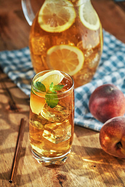 Peach Iced Tea Served with Lemon and Mint in a Glass