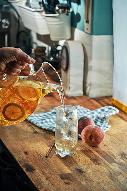 Peach Iced Tea Served with Lemon and Mint in a Glass