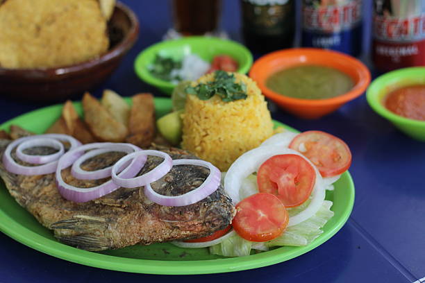 istock An appetizing serving of fried fish with rice and fresh vegetables arranged artfully, illustrating a balanced meal that evokes comfort and satisfaction. 2220462376
