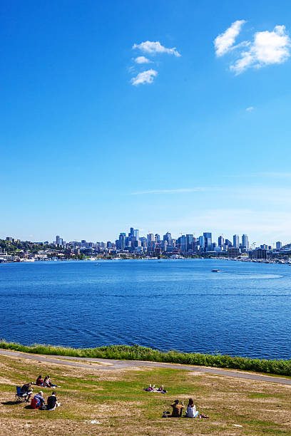 Lake Union houseboats cluster along the shoreline of the east side of the lake.  The Seattle skyline is in the background including the Space Needle.