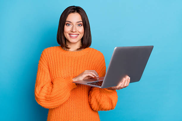 istock Portrait of attractive cheerful brown-haired girl using laptop developing project isolated over bright blue color background 2220462806