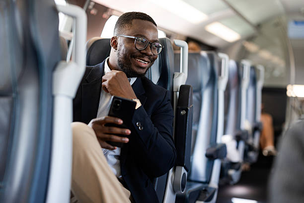 istock Businessman enjoying a commute on a modern train with a mobile phone 2220462934