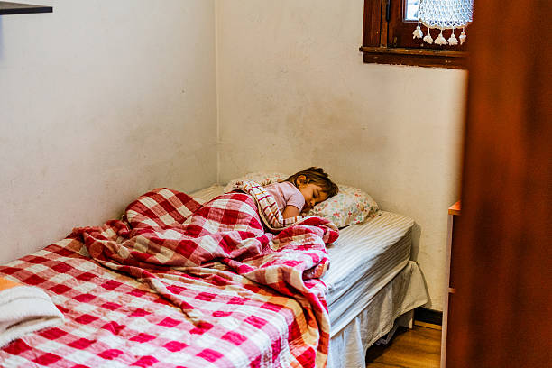 istock Little girl sleeping at home 2220464390