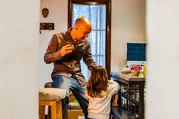 istock Father caring for his daughter while drinking yerba mate at home 2220464443