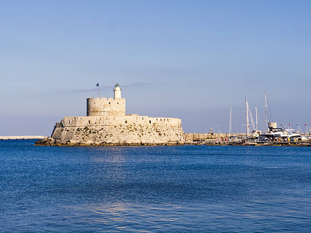 istock Rhodes island port fortress lighthouse and luxury yachts 2220464458