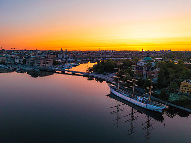 istock Stockholm skyline reflecting on water at sunset with a sailing ship docked 2220464532