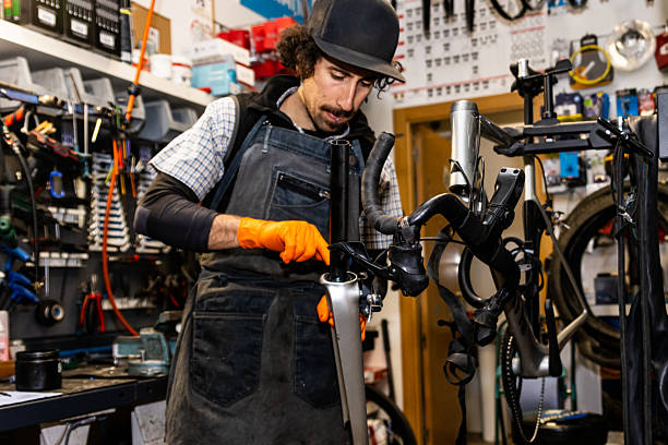 istock Bicycle mechanic repairing a bike in a workshop 2220465913