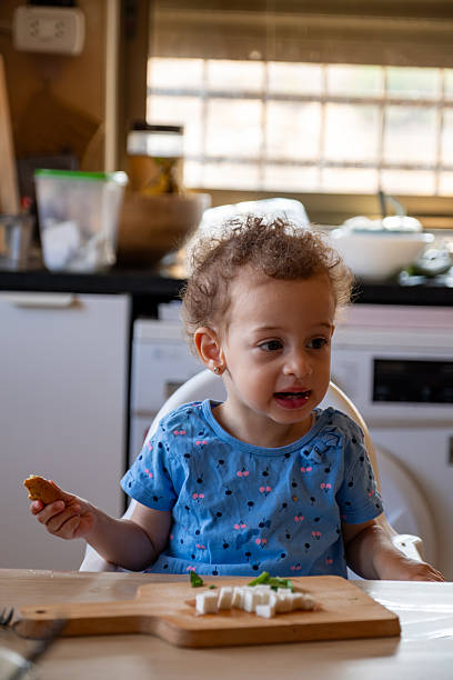 istock Young Child Enjoying a Healthy Snack in a Kitchen Setting 2220466552