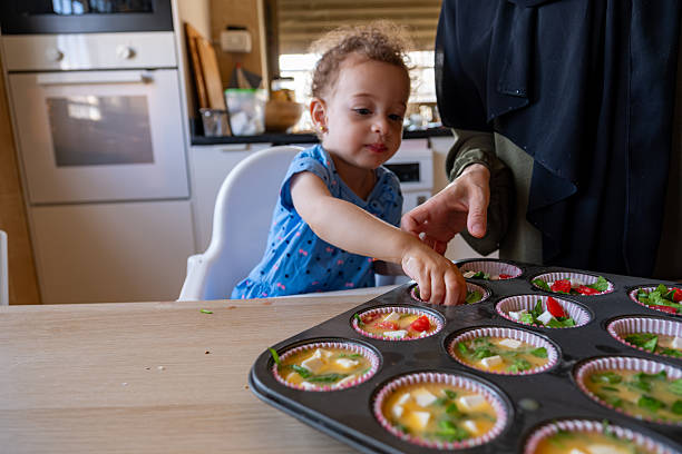 istock Mother and Child Baking Together in a Cozy Kitchen Setting 2220466667