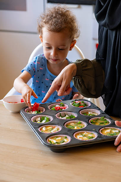 istock Mother and Child Baking Together in a Cozy Kitchen Setting 2220466679