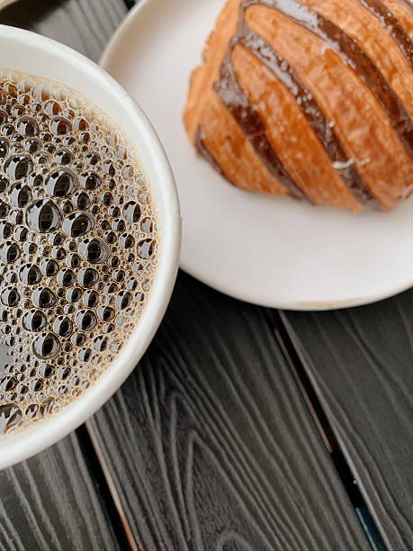 Delightful Hot Black Coffee with Bubbles & a Raspberry Chocolate Croissant in a Local Coffee Shop in Sunny West Palm Beach, Florida in May of 2025