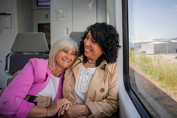 istock Senior lesbian couple traveling by train 2220467018