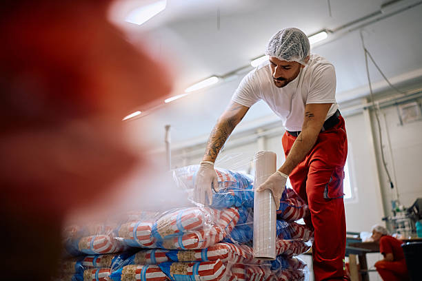 istock Food factory worker packing goods for a shipment. 2220467029