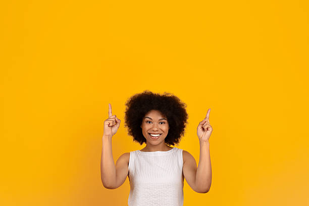 istock Great Offer. Black Woman Pointing Up At Copy Space Above Her Head 2220468237