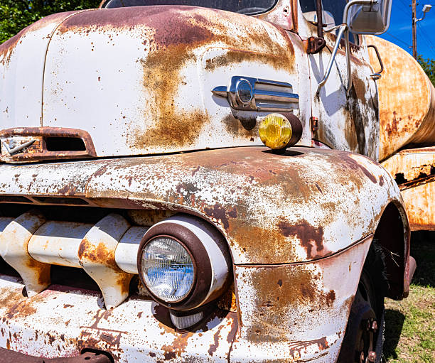Details of the bonnet of a Soviet military truck. Side turn signal lights. Design elements and details of an old camouflage surface with exfoliated paint on a military truck. Car detail. Close-up