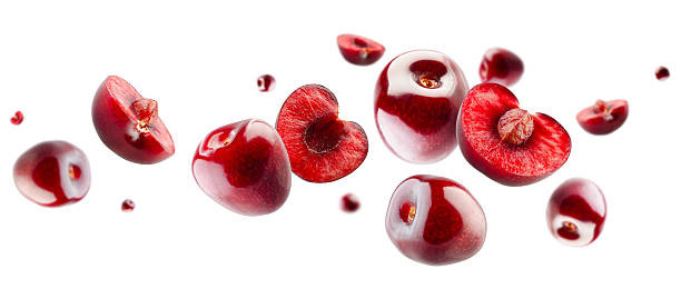 istock Cherry berries, whole and halves, form an unusual figure in space resembling a loop. Isolated on white 2220470766
