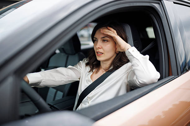 istock Stressed woman driving a car 2220471660