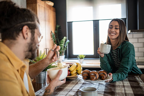 istock Young couple enjoying breakfast together in modern kitchen 2220471964