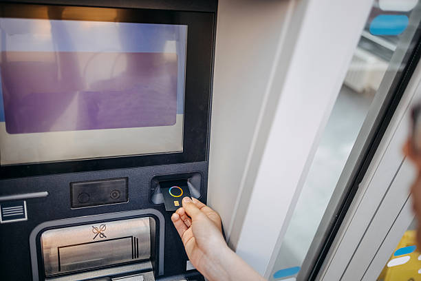 istock Hand pushing credit card in ATM machine 2220472050