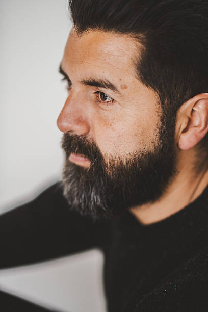 portrait of a man with tattooed hands at home