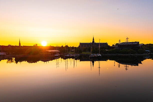 Scenic view of stockholm skyline reflecting in water at sunrise, with the nordic museum and vasa museum visible