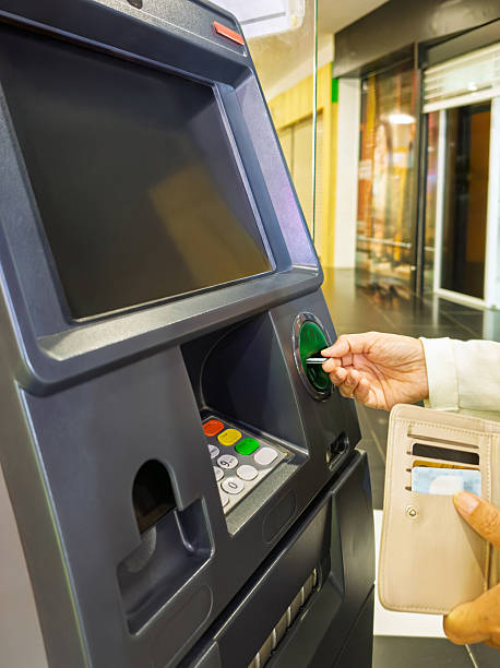 istock A hand inserting a bank card into an ATM machine 2220479504