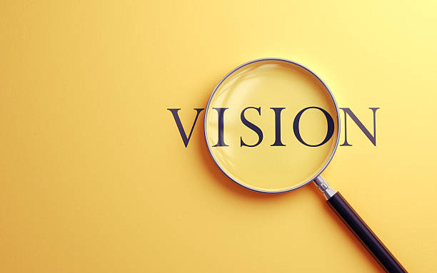 3d render Vision Text Selected with Metallic Magnifying Glass on Soft Yellow Background, It can be used for concepts such as Foresight and Working Life, (close-up)