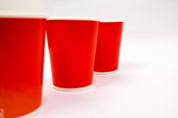 istock Three vibrant red paper cups lined up on a clean white surface, ready for beverages or creative projects with colorful design 2220479674