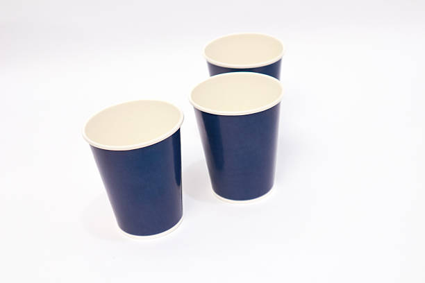 istock Three Navy Blue Paper Cups on a White Surface with Clean and Minimalist Style 2220480250