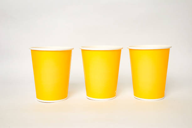 istock Three yellow paper cups on a white background, perfect for hot or cold drinks and easy to use in events 2220481122