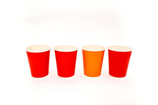 istock Colorful disposable paper cups lined up on a white background, ready for party 2220481128