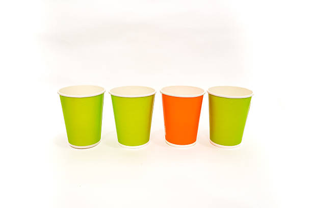 istock Colorful paper cups aligned in a row, standing on a white surface, simple minimalist studio setup 2220481293
