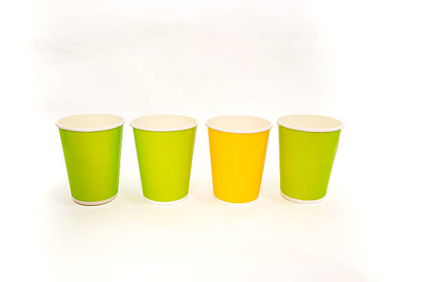 istock Vibrant Disposable Paper Cups: Green and Yellow Colors on a White Backdrop 2220481306