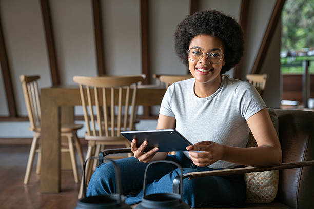 istock Portrait of a woman using a digital tablet at home 2220481785