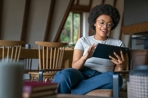 istock Happy young woman using a digital tablet at home 2220481789