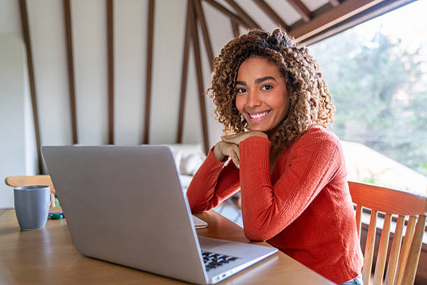istock Happy woman studying at home and looking at the camera smiling 2220481801