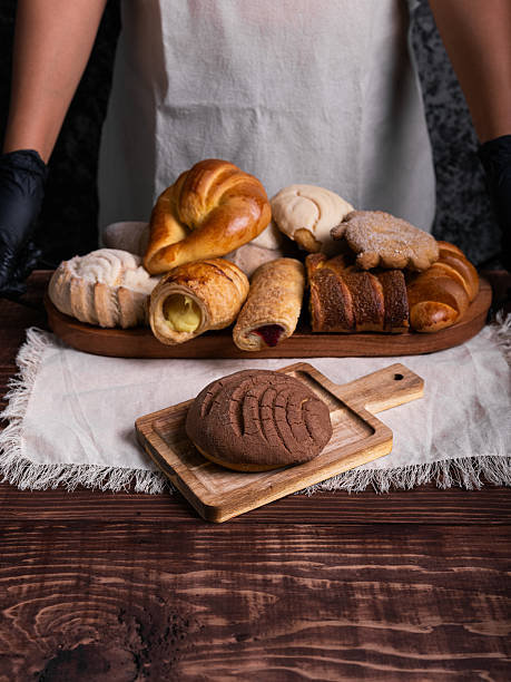 Chocolate concha bread on a rustic wooden table. stock photo