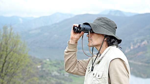 istock Mature Man Birdwatching In Nature. Middle Aged Pastimes 2220483107