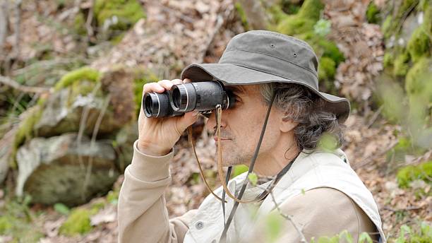 istock Explorer Birdwatching In Lush Green Forest 2220483124