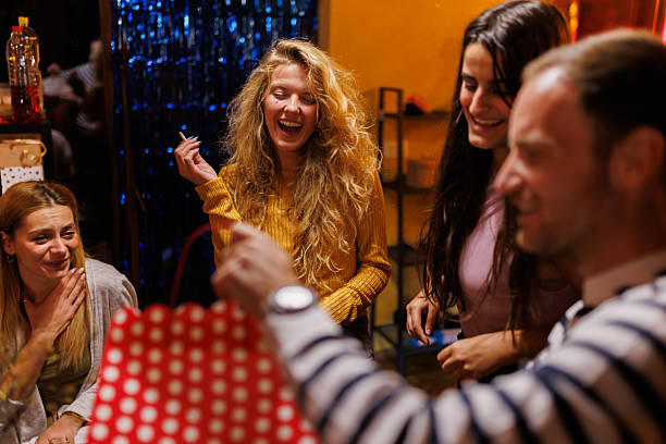 istock Group of Friends Enjoying Laughter During a Celebration in a Cozy Setting 2220483277
