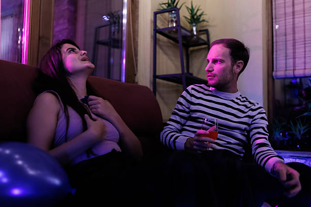 Two friends having a conversation while relaxing in a colorful ambiance