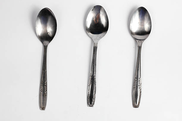 istock Bunch of iron spoons isolated on white background.interior home appliances 2220484358