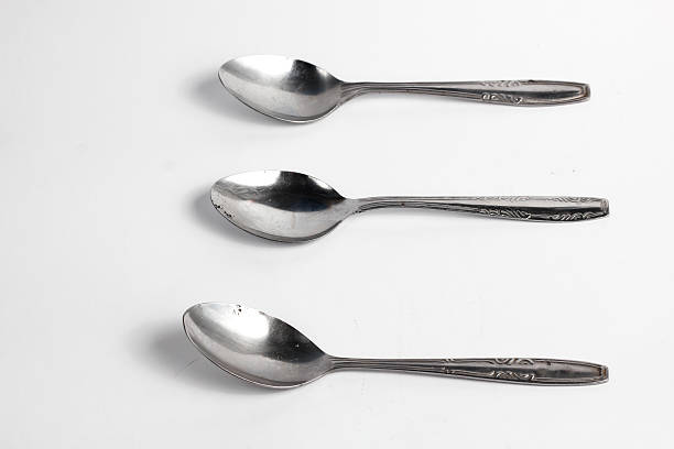 istock Bunch of iron spoons isolated on white background.interior home appliances 2220484579